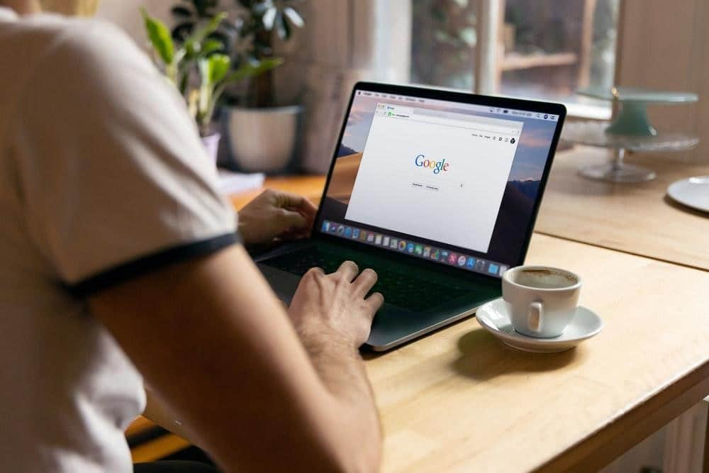 Person using a laptop with Google open on the screen