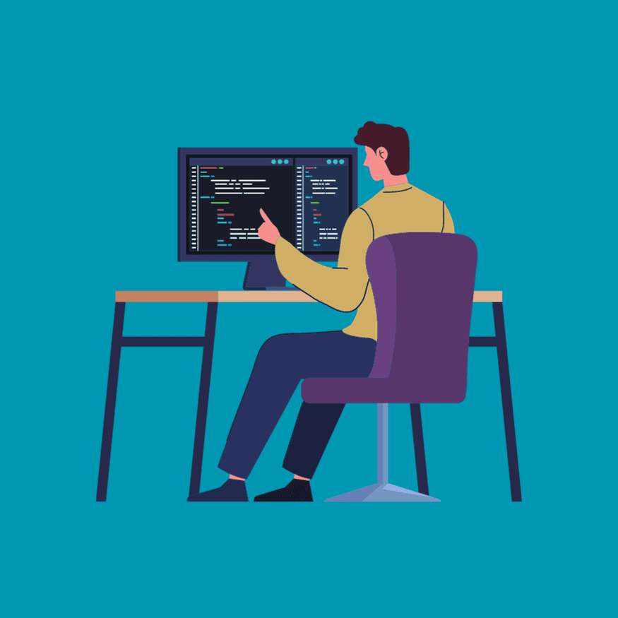 A man sits at desk in front of large desktop computer working on code